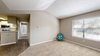 Located along SR-A1A in Jacksonville, FL, this single-floor, three-bedroom, two-bathroom residence offers a practical and comfortable layout. The floor plan connects three carpeted bedrooms, two full bathrooms, a hallway, a dedicated closet, and an in-unit laundry room. Each bedroom features neutral taupe walls, plush wall-to-wall carpeting, and windows fitted with horizontal blinds that allow generous natural light while providing privacy. The primary bedroom offers a vaulted ceiling, lending an open, airy feel to the space. A dedicated closet provides additional storage directly off one of the bedrooms. Both bathrooms are finished with wood-look plank flooring, white vanities with stone-look countertops, and tub-shower combinations with curved curtain rods. One bathroom features brushed nickel hardware, while the other showcases gold-toned accents. The in-unit laundry room accommodates a full-size washer and is equipped with an overhead wire shelving rack for added storage. Textured ceilings are present throughout the home. The residence provides a straightforward, well-organized layout suited to everyday living in a convenient Jacksonville location.
