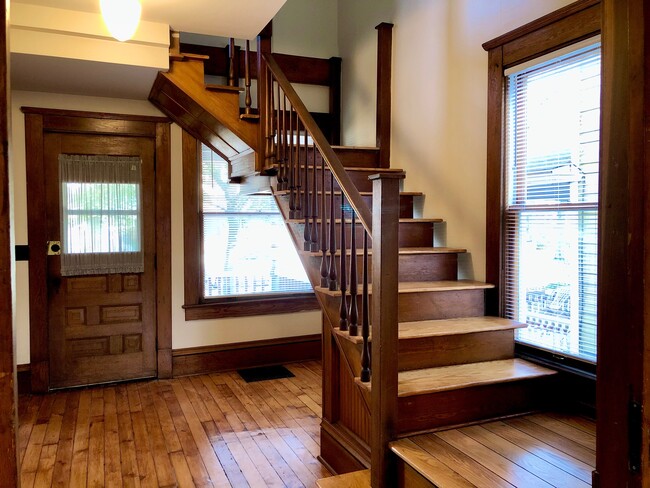 Front door and stairs that lead to upstairs bedroom and bathroom. - 1870 W 47th St