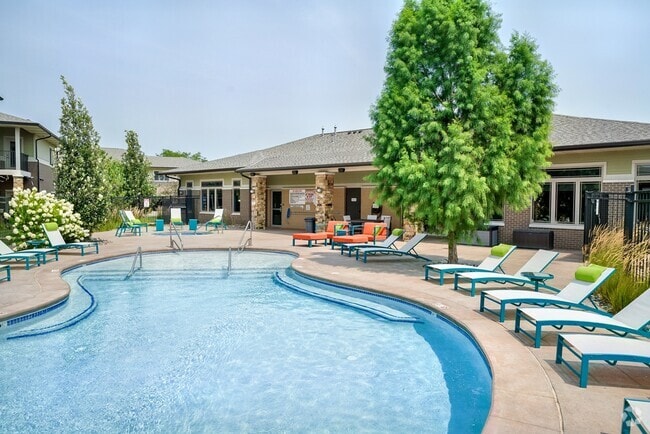 Our resort-style pool with lounge seating is the perfect place for relaxation. - The Villas at Wilderness Ridge