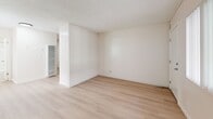 Located at 12534 S Inglewood Ave in Hawthorne, California, this efficiently designed single-floor unit offers a thoughtfully arranged layout comprising a living room, kitchen, bathroom, and closet. Light hardwood-style flooring runs throughout the space, lending a clean, cohesive aesthetic, while white walls and a textured ceiling contribute to a bright, airy atmosphere.

The living room is an open, well-lit area featuring a large window with vertical blinds that allows natural light to fill the room. The space is versatile and functional, with clean lines and neutral tones providing a blank canvas for various furnishing arrangements.

The kitchen is efficiently appointed with white cabinetry above and below the counter, a double-basin stainless steel sink, and a white gas range. Ample cabinet storage makes practical use of the available space. Adjacent to the kitchen is a sliding-door closet, offering convenient built-in storage.

The bathroom features a clean, all-white tub and shower surround, maintaining the unit's consistent bright and minimalist aesthetic. A vanity with a mirror and overhead lighting completes the bathroom.

Overall, this unit presents a clean, move-in-ready space with a consistent light color palette, maximizing the sense of openness throughout its compact footprint.