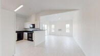 Located on the third floor at 16618 East Broadway Avenue in Spokane Valley, WA, Unit A307 is a thoughtfully designed multi-bedroom residence offering a clean, modern aesthetic throughout. The open-concept living and kitchen area serves as the heart of the unit, featuring light luxury vinyl plank flooring, vaulted ceilings, and an abundance of natural light from multiple windows. Sliding glass doors lead to a private balcony with outdoor views of the surrounding neighborhood and greenery.

The kitchen is well-appointed with white cabinetry, dark granite-style countertops, and a full suite of black appliances including a refrigerator, electric range, built-in microwave, and dishwasher. A peninsula provides additional workspace and separation from the living area.

The bedrooms offer comfortable accommodations, with carpeted flooring and large windows that bring in natural light and outdoor views. Closet space is available, including a walk-in closet in one of the bedrooms.

The bathrooms are finished with white cabinetry, dark countertops, and light vinyl plank flooring, maintaining the unit's cohesive color palette. One bathroom includes a tub/shower combination, while another offers a more compact layout. The unit's crisp white walls and consistent finishes create a bright, clean, and move-in-ready living environment.