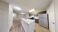 This 1,100 sq ft single-floor apartment at 6820 W Hillsborough Ave, Tampa, FL features 3 bedrooms, 2 bathrooms, and a thoughtfully designed open-concept layout. The kitchen is a standout, boasting dark wood cabinetry, a herringbone tile backsplash, stainless steel appliances including a refrigerator and electric range, and a large white quartz island with an undermount sink and a modern gooseneck faucet — ideal for cooking and entertaining. The kitchen flows seamlessly into the living room, which features wood-look plank flooring, neutral gray walls, a ceiling fan, and a glass door providing natural light and outdoor access. Each of the three bedrooms continues the wood-look flooring theme and includes a ceiling fan. The bedrooms offer ample closet space, with the primary bedroom spanning 140 sq ft. Two full bathrooms feature tub-shower combinations with white tile surrounds, wood-toned vanities with white countertops, and large mirrors. Additional highlights include two hallways, three closets, and consistent neutral-toned finishes throughout, creating a clean, cohesive aesthetic across the entire unit.