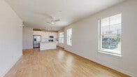 Located at 22360 Bushel Dr in Fairhope, Alabama, this single-story 2-bedroom, 2-bathroom home offers a bright and modern living experience. The open-concept layout seamlessly connects the living room and kitchen, both finished with light wood-look flooring and crisp white walls that amplify the natural light streaming in through multiple windows fitted with clean white blinds. Ceiling fans in the living areas provide year-round comfort.

The kitchen is a standout feature, boasting white shaker-style cabinetry, granite countertops, stainless steel appliances including a side-by-side refrigerator, range, and microwave, and a central island with pendant lighting and a built-in sink — ideal for both cooking and casual dining.

The bedrooms are well-proportioned and filled with natural light from large windows with outdoor views. The primary bedroom includes a spacious walk-in closet equipped with wire shelving for organized storage. Both bathrooms feature white cabinetry with granite countertops, and one includes a tub/shower combination. A private exterior door off one of the rooms adds convenient direct outdoor access, enhancing the home's functional layout throughout.
