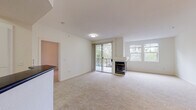 Located at 5095 Haven Pl in Dublin, CA, this single-floor residence offers a well-designed layout with a bright, open living area at its heart. The living room is finished with plush wall-to-wall carpeting and features a classic fireplace as a central focal point. A sliding glass door leads to a private balcony, filling the space with natural light and offering pleasant outdoor views of surrounding greenery. Large windows further enhance the airy, open ambiance throughout.

The kitchen is equipped with stainless steel appliances, including a gas range, oven, and over-the-range microwave, complemented by dark countertops and clean white cabinetry with modern hardware. Wood-style flooring grounds the kitchen and flows into the bathrooms.

The bedrooms are generously sized, carpeted for comfort, and bathed in natural light from large windows with outdoor views. One bedroom includes access to a spacious walk-in closet with built-in shelving and hanging rods. A dedicated vanity area with dark countertop and mirror adds a practical touch to the primary suite.

The bathrooms are well-appointed, featuring white vanities with dark countertops. One full bathroom includes a shower-tub combo with sliding glass doors, while a second bathroom serves as a convenient half bath. The overall palette of neutral tones and clean finishes gives the home a fresh, move-in ready feel.