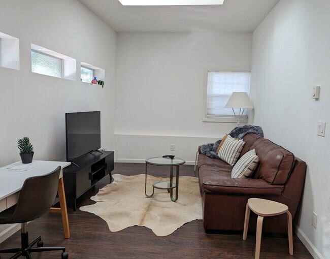 Living room with skylights and workspace - 26 Saddle Brook Ct