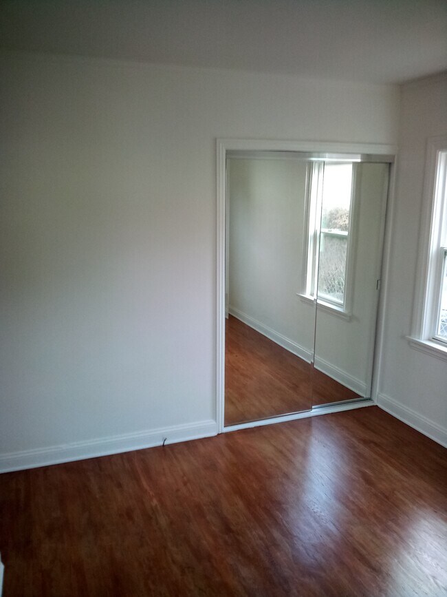 Bedroom with sliding mirrored closet door - 9055 Lucerne Ave