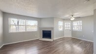 Located at 2614 S Miller Dr in Lakewood, Colorado, this well-appointed 2-bedroom, 2-bathroom single-floor home offers a practical and comfortable layout. The living room serves as the heart of the space, showcasing rich hardwood-style flooring, a classic brick fireplace as a focal point, a ceiling fan, and multiple windows that invite generous natural light and outdoor views. A dedicated entry door adds convenience and separation from the main living area. The kitchen is complemented by an adjacent pantry, providing useful storage for everyday essentials, while an in-unit laundry area adds practical convenience. Both bedrooms are carpeted for warmth and comfort, each featuring natural light from windows and access to closets — with four closets total throughout the home providing exceptional storage. The primary bedroom benefits from its own dedicated bathroom access. A connecting hallway ties the rooms together with clean, neutral finishes including brushed nickel hardware details visible throughout. A private balcony extends the living space outdoors. Textured ceilings and soft gray wall tones give the home a cohesive, move-in-ready aesthetic throughout.