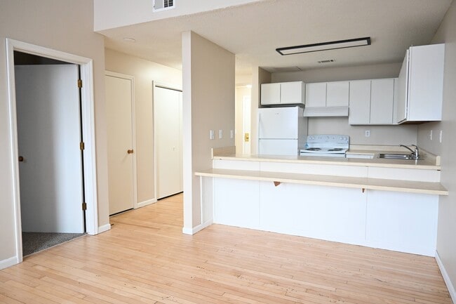 Kitchen and front entrance of a unit at Rosewater. - Rosewater Apartments