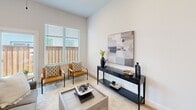 Located at 550 NW E. Crawford Ave in Fate, TX, this single-story, 2-bedroom, 3-bathroom home offers a thoughtfully designed layout with a clean, modern aesthetic throughout. The open-concept living, dining, and kitchen area serves as the heart of the home, bathed in natural light from large windows dressed with blinds. The living space features elevated ceilings, a ceiling fan, and light neutral tones that create a bright, airy atmosphere.

The kitchen is a standout feature, boasting crisp white shaker cabinetry, white quartz countertops, stainless steel appliances, a matte black faucet, and a spacious island with bar seating — ideal for casual dining or entertaining. An adjacent pantry provides additional storage convenience.

The primary bedroom offers a comfortable retreat with plush carpet, elevated ceilings, a ceiling fan, and windows that invite natural light. Its en-suite bathroom features a white dual-vanity with black hardware accents and a glass-enclosed walk-in shower with tile surround. The second bedroom also includes carpet flooring, a large closet with double doors, and ample natural light.

Additional highlights include four closets, two hallways, a dedicated laundry room with full-size washer and dryer hookups, and a backyard accessible through sliding glass doors. The home's consistent use of light finishes and modern fixtures creates a cohesive, inviting environment throughout.