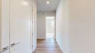 Located on North Commerce Street in Milwaukee, WI, this two-bedroom, two-bathroom residence blends modern finishes with industrial character across a single, well-designed floor. The open-concept kitchen and living area serves as the heart of the home, highlighted by exposed wooden beams, visible ductwork, and light hardwood flooring that together create a warm loft-inspired aesthetic. The kitchen is outfitted with white shaker cabinetry, granite countertops, stainless steel appliances, and a double sink—offering both style and functionality. Large windows throughout the living area flood the space with abundant natural light and frame views of the surrounding Milwaukee streetscape. The two bedrooms are carpeted for comfort, each featuring generous closet space with sliding doors and bright windows overlooking the neighborhood. With four closets total, storage is plentiful throughout the unit. The two bathrooms are finished with dark tile flooring and include a full tub-shower combination. A dedicated entrance and private balcony round out the layout, adding everyday convenience and an inviting outdoor retreat. Clean lines, neutral tones, and thoughtful details make this a bright and functional urban residence.