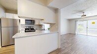 Located at 7021 W McDowell Rd in Phoenix, Arizona, this single-floor residence offers a clean, modern interior with a cohesive design throughout. Wood-look flooring runs seamlessly across the living areas and bedrooms, providing a warm and durable foundation underfoot, while textured ceilings add a classic finishing touch to each room.

The kitchen is a functional highlight, featuring a peninsula with a marble-style countertop that opens toward the living area, promoting an easy flow between spaces. Stainless steel appliances — including a range, over-the-range microwave, and refrigerator — are paired with white cabinetry for a bright, contemporary look.

The living area is generously proportioned and benefits from a ceiling fan with integrated lighting, ensuring year-round comfort. Natural light filters in through multiple windows across the bedrooms, each of which offers ample wall space and connects to the rest of the unit via a well-designed layout. One bedroom provides direct access to the bathroom, which includes a wide white vanity with marble-style countertop, a full mirror, and a shower-tub combination. The clean, neutral palette throughout the entire residence creates a bright and welcoming ambiance well-suited to the sunny Phoenix environment.