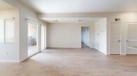 This well-appointed 2-bedroom, 2-bathroom residence in National City, CA offers a thoughtfully designed single-level layout with consistent wood-style flooring flowing throughout every room. The open-concept kitchen and living area serves as the heart of the home, featuring rich warm-toned cabinetry extending to the ceiling for ample storage, granite countertops, and a full suite of stainless steel appliances including a refrigerator, gas range, microwave, and dishwasher. A peninsula with an overhang provides casual seating and defines the kitchen from the living space. The living room is generously proportioned, bathed in natural light through large sliding glass doors that open to an outdoor area. Both bedrooms are comfortably sized, each highlighted by windows with blinds that allow natural light while maintaining privacy, with views of the surrounding neighborhood. The primary bedroom offers a notably spacious footprint. Both bathrooms share a consistent design, each featuring a full tub-shower combination with white tile surround, a wood-toned vanity, and wood-style flooring. Clean white walls and neutral finishes throughout create a bright, move-in-ready atmosphere well-suited to a variety of living styles.