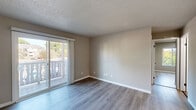Located at 2143 Bollman Dr in Sheboygan, WI, this 2-bedroom, 1-bathroom unit offers a well-designed single-floor layout with a clean, updated aesthetic throughout. Light-toned luxury vinyl plank flooring flows consistently across all rooms, complemented by neutral beige walls and crisp white trim.

The living room is a bright, open space anchored by a sliding glass door that opens onto a private balcony, allowing abundant natural light and outdoor views of the surrounding neighborhood. A wall-mounted AC unit provides in-unit climate control.

The kitchen stands out with white shaker-style cabinetry, black hardware accents, light granite-look countertops, a subway tile backsplash, and stainless steel appliances including a dishwasher and refrigerator. A large pantry closet adds practical storage.

Both bedrooms feature the same LVP flooring and neutral tones. The primary bedroom includes a sliding double-door closet, while the second bedroom benefits from a large window with views of mature trees. The full bathroom is finished in clean whites, featuring a tub-shower combo with black fixture accents and a vanity with under-sink storage.

Textured ceilings are present throughout, adding a classic touch to this thoughtfully updated home.