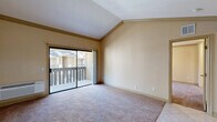Located at 3535 Banbury Dr in Riverside, CA, this one-bedroom, one-bathroom unit offers a thoughtfully designed single-floor layout that maximizes comfort and functionality. The open-concept living area features warm neutral tones, plush carpeting, and vaulted ceilings that create an airy sense of space. A sliding glass door floods the room with natural light and opens directly onto a private balcony, providing outdoor views of the surrounding community. The kitchen is well-appointed with rich wood cabinetry, granite countertops, a breakfast bar, stainless steel appliances including a refrigerator, microwave, and range, and a double-basin sink. Light tile flooring and a skylight-style ceiling fixture enhance the brightness of the kitchen space. The generously sized bedroom includes plush carpeting, a ceiling fan with light, and a window that brings in additional natural light. The bathroom features a full tub-shower combination with clean white finishes and tile flooring. A dedicated closet provides convenient storage. Ceiling fans throughout the unit ensure year-round comfort, and a wall-mounted HVAC unit in the living area adds climate control convenience.