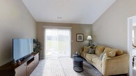 Located at 2753 Michaelsway Ave in Lancaster, Ohio, this single-floor residence offers a comfortable and well-appointed living environment. The living area serves as the heart of the home, showcasing neutral-toned walls that create a warm and inviting atmosphere. Plush carpeting underfoot adds comfort and softness to the space, while a sliding glass door fitted with vertical blinds floods the room with generous natural light and provides seamless access to the outdoors. The view through the glass door reveals a lush green landscape, bringing a sense of openness and connection to nature into the interior. The layout is thoughtfully designed to accommodate both relaxation and everyday living, with ample space for furnishings and movement. The vaulted ceiling adds to the sense of volume within the room, contributing to an airy and spacious feel. Neutral wall colors and light-toned ceilings keep the space feeling fresh and versatile. Overall, the home presents a clean, move-in-ready aesthetic with practical features and a peaceful, light-filled ambiance that makes it well-suited for comfortable single-level living in Lancaster, Ohio.