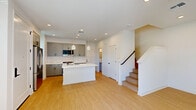 Located at Stanford Crossing in Lathrop, CA, this modern two-story home offers a well-designed layout across two floors. The ground floor features an open, light-filled living area with smooth light hardwood flooring, recessed lighting, and a staircase that connects seamlessly to the upper level. A half bathroom on this floor provides added convenience for guests.

The kitchen is a standout feature, showcasing gray shaker-style cabinetry, crisp white quartz countertops, a subway tile backsplash, and a full suite of stainless steel appliances including a refrigerator, dishwasher, and range. A central island with an integrated sink and pendant lighting above adds both function and style. The attached garage offers direct interior access and features a clean concrete floor.

Upstairs, the two bedrooms are bright and airy, each benefiting from multiple windows with natural light and views of the surrounding neighborhood. The primary bedroom includes a spacious walk-in closet with built-in shelving and hanging rods. The four bathrooms are finished in a clean, contemporary style with modern fixtures. A dedicated laundry room with side-by-side LG washer and dryer units and overhead shelving adds everyday practicality to this well-appointed home.