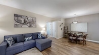 Located at 840 Auburn Hill Dr in Indianapolis, IN, this 2-bedroom, 2-bathroom single-floor residence offers a thoughtfully designed layout that maximizes comfort and functionality. The open-concept living, dining, and kitchen area serves as the heart of the home, with durable wood-look flooring flowing throughout the main spaces. The living room is bright and welcoming, featuring sliding glass doors with vertical blinds that open to an outdoor area, allowing natural light to fill the room. The dining area sits adjacent to the living room and provides an intimate space for meals. The galley-style kitchen is efficiently organized with ample white cabinetry, a double sink, full appliance suite, and light countertops. Both bedrooms are carpeted and include closets, with the primary bedroom featuring a dedicated walk-in closet with built-in shelving. The second bedroom is versatile and well-suited as a home office or guest room, complete with a large window. Two full bathrooms feature wood-look flooring and clean, neutral finishes. Additional spaces include three closets, a laundry area, and a utility room, ensuring plentiful storage. Neutral warm-toned walls and consistent finishes throughout create a cohesive and inviting ambiance.