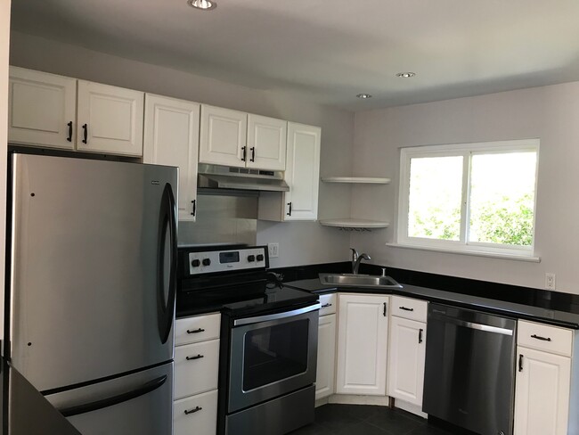 Kitchen features beautiful tree-lined view; updated stainless steel appliances - 6484 Cavalleri Rd