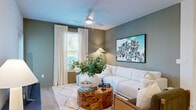 Located at 14945 Sabiki Loop in Bradenton, FL, this single-story, 2-bedroom, 2-bathroom home offers a thoughtfully designed layout with modern finishes throughout. Light wood-style flooring flows seamlessly across the open living areas, complementing the neutral sage-green accent walls that add warmth and character to the space.

The kitchen is a standout feature, showcasing two-tone cabinetry with sage-green lower cabinets, crisp white uppers, white quartz countertops, a subway tile backsplash, and stainless steel appliances. A generous center island with seating and pendant lighting overhead makes it both functional and inviting.

The living room offers a comfortable, open feel with a ceiling fan, large windows allowing ample natural light, and direct access to the outdoors. Both bedrooms are well-proportioned, with the primary bedroom featuring natural light from dual windows and access to a dedicated walk-in closet with wire shelving systems. A second walk-in closet serves the additional bedroom.

The bathrooms are finished with white shaker-style vanities, black hardware accents, and wood-look flooring. One bathroom includes a tub-shower combination. Additional conveniences include an in-unit laundry area. The home presents a cohesive, contemporary aesthetic throughout.