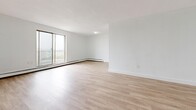 Located at 520 Mornington Ave in London, Ontario, this 2-bedroom, 1-bathroom unit offers a clean, modern interior across a well-organized single floor. Light wood-style flooring runs throughout, complementing the crisp white walls and creating a bright, cohesive aesthetic.

The spacious living room is a standout feature, bathed in natural light through large sliding glass doors that open to a private balcony with outdoor views. Baseboard heating lines the perimeter, ensuring comfort year-round.

The kitchen is well-appointed with white shaker-style cabinetry, dark stone-look countertops, a double stainless steel sink with a modern pull-down faucet, and a classic white subway tile backsplash — a practical and stylish space for everyday cooking.

Both bedrooms are generously sized, each featuring light flooring, natural window light, and ample closet storage with double built-in closets. The primary bedroom offers particularly notable storage capacity.

The bathroom is tastefully updated, showcasing white subway tile surround, a floating dark wood vanity with a white stone countertop, an integrated sink, and a large mirror — offering a clean, contemporary finish.

Overall, the unit presents a bright, neutral, and move-in ready interior with modern finishes throughout.