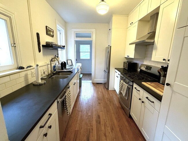 Building Photo - Remodeled 2 Bed / 2 Bath ½ Townhome | Private Rooftop Patio + Detached Garage |  Available Early ...