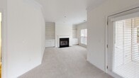 This 900 square foot single-floor apartment offers a well-designed living space with one bedroom and one bathroom. The open-concept layout seamlessly integrates the kitchen, living, and dining areas, maximizing the use of space. The living room is the heart of the home, featuring a cozy fireplace flanked by built-in shelving and cabinets, perfect for storage and display. Large windows allow ample natural light, brightening the neutral-toned interior.

The modern kitchen boasts white cabinetry, dark countertops, and wood flooring, creating a striking contrast. A breakfast bar separates the kitchen from the living area, providing additional seating and prep space. The bedroom, at 190 square feet, offers a spacious retreat with plush carpeting and a large window. The bathroom is efficiently designed with a combined tub and shower, single vanity, and modern fixtures.

Throughout the apartment, neutral colors dominate, with off-white walls and beige carpeting in the living areas and bedroom. This color scheme provides a blank canvas for personalization. The apartment's layout, as seen in the 3D floor plan, shows a thoughtful arrangement that maximizes functionality in a compact space, making it ideal for singles or couples seeking a comfortable, low-maintenance home.
