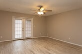 Located at 1755 20th Ave Dr NE in Hickory, NC, this single-story, one-bedroom, one-bathroom home offers a practical and well-organized layout across a comfortable footprint. The living area is bright and open, featuring light hardwood-style flooring, neutral wall tones, a textured ceiling, a ceiling fan with light kit, and a set of French doors that allow natural light to flow in and provide access to the outdoors. The kitchen is thoughtfully designed with white cabinetry, dark countertops, light hardwood-style flooring, and stainless steel appliances including a refrigerator and electric range with an overhead ventilation hood. A peninsula counter adds additional workspace and a natural divide between the kitchen and living areas. The bedroom is generously sized, carpeted for comfort, and includes a ceiling fan, a window for natural light, and access to a dedicated closet. The full bathroom features wood-look tile flooring, a shower-tub combo, toilet, and a vanity with storage. A hallway connects the rooms efficiently, and a dedicated entrance completes the functional single-floor layout of this Hickory residence.
