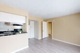 Located at 15530 Ella Blvd in Houston, TX, this one-bedroom, two-bathroom unit offers a well-organized single-floor layout designed to maximize every square foot. The open-concept living, dining, and kitchen area forms the heart of the space, creating a seamless flow for daily living. Light wood-style flooring runs throughout, complementing the warm beige tones of the walls and crisp white trim.

The kitchen is a standout feature, showcasing bold black marble-patterned countertops that contrast elegantly with white cabinetry. It is equipped with a black electric range, vent hood, and refrigerator, along with a dedicated countertop pass-through that connects to the dining and living area — ideal for entertaining or casual meals.

The bedroom is a comfortable, well-proportioned space with natural light streaming in through a sizable window with blinds, offering views of the surrounding greenery. The room features the same light flooring found throughout the unit, creating a cohesive feel.

Two full bathrooms serve the unit, each featuring a full tub-shower combination with tile surround. A dedicated closet provides additional storage. The overall ambiance of this unit is clean, bright, and functional — a practical yet inviting space in a convenient Houston location.