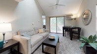 Located at 131 Ridgefield, this single-floor residence offers a well-appointed layout designed with everyday comfort in mind. The living area immediately stands out with its dramatic vaulted ceiling and ceiling fan, creating an open, airy atmosphere. Soft carpeting underfoot adds warmth, while a large sliding glass door floods the space with natural light and provides direct access to a private outdoor deck. A dedicated dining area sits adjacent to the living space, offering a seamless flow for entertaining.

The kitchen is efficiently designed and well-equipped, featuring white cabinetry with brushed nickel hardware, dark granite-style countertops, and stainless steel appliances including a refrigerator, electric range, and dishwasher. Light tile flooring and a textured ceiling complete the functional aesthetic.

The bedroom is a calm, comfortable retreat with plush carpet, neutral walls, and a window that invites natural light. A closet with accessible storage is conveniently located just off the room.

The bathroom is clean and practical, featuring a tub and shower combination, a wood-trimmed vanity with a white countertop, tile flooring, and a mirrored medicine cabinet. Throughout the unit, the design emphasizes functionality and a welcoming, neutral palette.