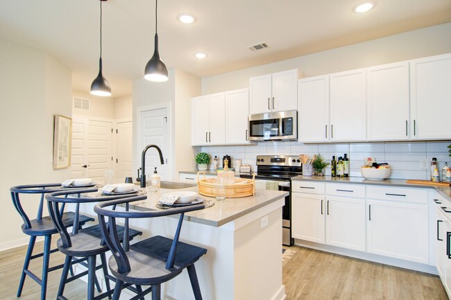 Designer grey or white shaker-style cabinetry with high-end tile backsplash - Cadence