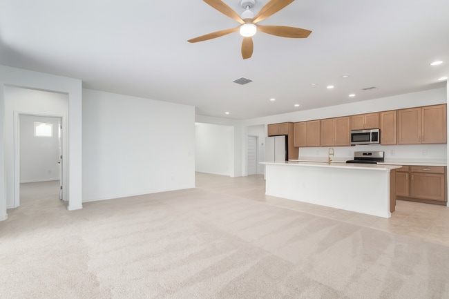 Living room, kitchen, dining room, and primary bedroom - 10223 W Piccadilly Rd