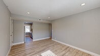 Located at 625 S 35th St in Omaha, Nebraska, this single-story 2-bedroom, 1-bathroom home offers a clean, updated living experience with modern finishes throughout. Light wood-look flooring runs consistently across the home, complemented by soft gray walls and crisp white trim, creating a cohesive and contemporary feel.

The living room is open and airy, with recessed lighting and natural light filtering through window blinds. It flows naturally toward the combined dining and kitchen area, which is a standout feature of the home. The kitchen is equipped with gray shaker-style cabinetry, white quartz countertops, a subway tile backsplash, stainless steel appliances, and a window overlooking the neighborhood — a bright and functional space for cooking and dining.

Both bedrooms are well-proportioned, with the primary bedroom offering generous space, a ceiling fan with light fixture, multiple windows for natural light, and easy outdoor views. The second bedroom also features a closet and a window, keeping the room bright and practical. A hallway connects the bedrooms and includes additional closet storage.

The bathroom features a tub-shower combination with elegant marble-look tile surround, brushed nickel fixtures, a gray vanity with white countertop, and a mirrored medicine cabinet. The home also includes a dedicated laundry area and utility room, adding everyday convenience.