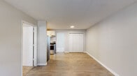 Located at 116 Brock St in Carrollton, Georgia, this single-floor, 3-bedroom, 1-bathroom home offers a practical and well-appointed layout with clean, modern finishes throughout. The living area features light wood-style flooring and neutral gray walls, creating a bright and open atmosphere. A dedicated entry point with a window unit provides natural light and ventilation to the main living space.

The kitchen is designed in a galley style, featuring white shaker cabinetry, granite countertops, a stainless steel refrigerator, electric range, and a modern pull-down faucet over a stainless steel sink. White subway tile backsplash adds a clean, contemporary touch.

The bedrooms are carpeted and equipped with ceiling fans for comfort. The spacious primary bedroom includes a window for natural light, a ceiling fan, and an adjacent vanity area with white cabinetry and granite countertops. The bathroom features a full tub-shower combination with tile surround and wood-style flooring.

Additional bedrooms are well-sized with neutral carpet and ceiling fans. One bedroom area opens directly to the main living space, which also includes a large double-door closet. The home's cohesive color palette and updated finishes make it a move-in ready residence in Carrollton, GA.
