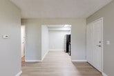 Located at 10555 W Jewell Ave in Lakewood, Colorado, this one-bedroom, one-bathroom unit offers a practical and efficiently designed single-floor layout. Throughout the space, light wood-style flooring and soft neutral gray walls create a clean, cohesive aesthetic complemented by white trim and textured ceilings.

The living area provides an open, functional space with baseboard heating and natural light filtering in through blinded windows. It connects seamlessly to the kitchen, which is defined by a bright overhead light panel, white upper cabinetry, and a full suite of stainless steel appliances including a refrigerator, range, and over-the-range microwave. The kitchen offers a tidy, efficient workspace with ample room to move.

The bedroom is a well-proportioned retreat featuring two windows that bring in natural light and views of greenery outside, along with a closet for storage and baseboard heating to maintain comfort year-round.

The bathroom is finished with wood-style flooring, a white tiled tub-shower combination, a vanity with granite-style countertop, and brushed nickel hardware and fixtures throughout, giving the space a polished, functional feel.

Overall, this unit presents a straightforward, move-in-ready layout well-suited for those seeking a manageable, low-maintenance home in Lakewood.