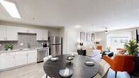 Located at 5145 Rawhide St in Las Vegas, NV, this thoughtfully designed 2-bedroom, 2-bathroom unit offers a efficient and modern single-floor layout. The open-concept kitchen and living area serves as the heart of the home, featuring white shaker cabinetry, granite countertops, a grey subway tile backsplash, and a full suite of stainless steel appliances including a refrigerator, dishwasher, gas range, and microwave. Light wood-style flooring runs throughout, enhancing the bright and airy feel of the space.

The living room is anchored by a striking dark slatted accent wall, a ceiling fan, and a sliding glass door that invites natural light and outdoor views. The primary bedroom continues the bold design aesthetic with a matching dark slatted feature wall, a ceiling fan, and ample room for a full bedroom suite. The second bedroom offers a more relaxed atmosphere with closet access and its own ceiling fan.

Both bathrooms are finished with white cabinetry, granite countertops, and clean tile flooring. One bathroom includes a tub-shower combination, while the other features a walk-in shower setup. A connecting hallway ties all spaces together seamlessly, creating a cohesive and well-organized floor plan ideal for comfortable everyday living.