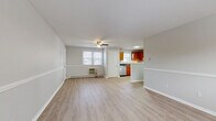 Located at 169 School St in Hamden, Connecticut, this one-bedroom, one-bathroom residence offers a practical and well-organized single-floor layout. The combined living and dining area forms the heart of the home, featuring light wood-look vinyl flooring, neutral gray walls with a distinctive chair-rail detail, a ceiling fan with light fixture, and windows that invite natural light. A wall-mounted AC unit and baseboard heating ensure year-round comfort.

The kitchen is efficiently designed with warm honey-toned wood cabinetry, dark countertops, a stainless steel refrigerator, electric range, and dishwasher, along with a window above the sink for added brightness. A hallway connects the main living areas to the bedroom and bathroom.

The spacious bedroom is finished with plush carpet flooring, soft neutral walls, and a window with a view to the outdoors, complemented by baseboard heating. Three closets throughout the unit provide generous storage.

The bathroom features a full tub and shower combination with classic tiled surround. A dedicated utility room rounds out the layout. With its clean finishes, functional design, and convenient Hamden location, this residence offers a comfortable and efficient living environment.
