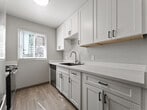 Located at 154 Richardson Dr in Vallejo, California, this ground-floor apartment offers a well-organized single-level layout designed for comfortable living. The open living and dining area features wood-look plank flooring, neutral gray walls, and a ceiling fan, creating a bright and airy atmosphere. Sliding glass doors with vertical blinds lead to a private patio that brings in abundant natural light and outdoor views. A baseboard heating system provides reliable climate control throughout the common areas.

The kitchen is thoughtfully updated with crisp white cabinetry accented by matte black hardware, sparkling quartz countertops, a black composite sink with a modern faucet, and stainless steel appliances. A window above the counter allows natural light to fill the workspace.

The unit includes multiple bedrooms, each carpeted and finished with neutral tones. Each bedroom features a sliding mirrored closet or a dedicated walk-in closet, offering generous storage. Textured popcorn ceilings are consistent throughout the unit.

The bathroom is well-appointed with a white vanity, vessel sink, quartz countertop, and a shower-tub combination, all finished with wood-look flooring. The overall design reflects a clean, move-in-ready aesthetic suited for everyday living in Vallejo, CA.