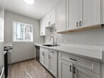 Located at 154 Richardson Dr in Vallejo, California, this ground-floor apartment offers a well-organized single-level layout designed for comfortable living. The open living and dining area features wood-look plank flooring, neutral gray walls, and a ceiling fan, creating a bright and airy atmosphere. Sliding glass doors with vertical blinds lead to a private patio that brings in abundant natural light and outdoor views. A baseboard heating system provides reliable climate control throughout the common areas.

The kitchen is thoughtfully updated with crisp white cabinetry accented by matte black hardware, sparkling quartz countertops, a black composite sink with a modern faucet, and stainless steel appliances. A window above the counter allows natural light to fill the workspace.

The unit includes multiple bedrooms, each carpeted and finished with neutral tones. Each bedroom features a sliding mirrored closet or a dedicated walk-in closet, offering generous storage. Textured popcorn ceilings are consistent throughout the unit.

The bathroom is well-appointed with a white vanity, vessel sink, quartz countertop, and a shower-tub combination, all finished with wood-look flooring. The overall design reflects a clean, move-in-ready aesthetic suited for everyday living in Vallejo, CA.