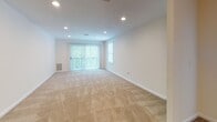 Located at 26 Waterfall Dr in Canton, MA, this single-floor residence offers a well-organized layout with a cohesive, neutral design aesthetic throughout. The living area is generously proportioned, featuring plush wall-to-wall carpeting, recessed lighting, and a sliding glass door that invites natural light and provides outdoor views, creating a bright and welcoming atmosphere.

The kitchen is well-appointed with light wood cabinetry, dark granite-style countertops, and a full suite of stainless steel appliances, including a range, microwave, and dishwasher. Tile flooring and under-cabinet lighting lend a clean, functional character to the space.

The bedrooms are carpeted and finished in warm, neutral tones. Several rooms feature windows with blinds that allow for natural light, while one room showcases a vaulted ceiling detail that adds architectural interest. Closet space is provided with sliding panel doors for convenient storage.

Two bathrooms serve the home: a full bath with a tub-shower combination, white cabinetry, and tile flooring, and a second bath featuring a corner neo-angle shower enclosure with chrome hardware. Both bathrooms maintain a clean, bright finish throughout.
