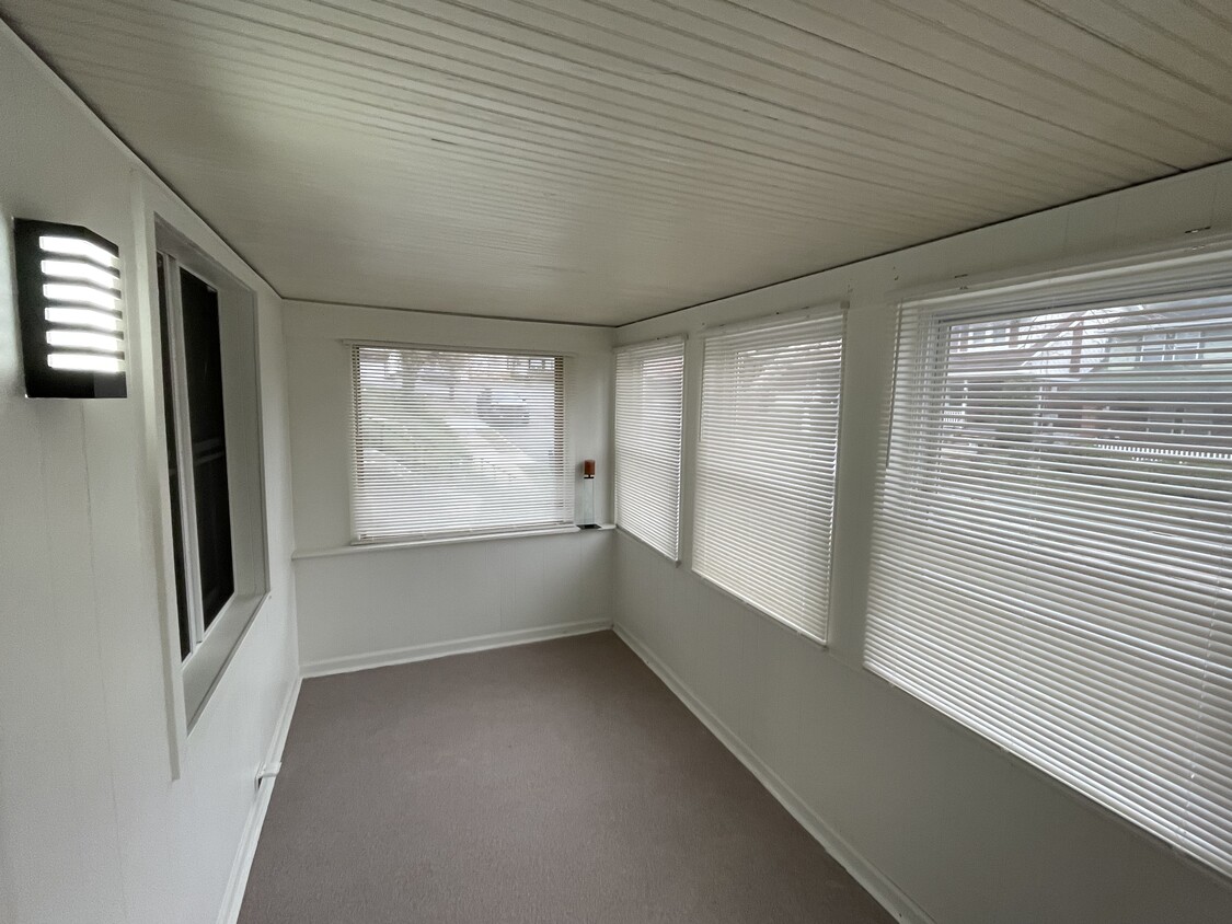 Pleasant sunroom with fresh nature stone flooring. - 212 Lorenz Ave