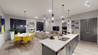 This single-story residence at 11844–11878 W 36th St in Little Rock, Arkansas, showcases a contemporary open-concept design that seamlessly connects the kitchen, dining, and living areas. The kitchen is a standout feature, equipped with white shaker-style cabinetry, stainless steel appliances, subway tile backsplash, and a large central island topped with white quartz countertops. Stylish pendant lighting hangs above the island, which offers bar seating for casual dining. Light wood-style flooring flows throughout the main living areas, enhancing the bright, cohesive aesthetic.

The living room provides a comfortable gathering space with recessed lighting, a ceiling fan, and a neutral color palette. A designated dining area adjoins the space, completing the open-plan layout. The bedrooms are carpeted for comfort, with the primary bedroom featuring a walk-in closet outfitted with built-in shelving and hanging rods for well-organized storage.

The bathroom includes marble-look tile flooring, a sliding glass tub-shower enclosure with tiled surround, and a clean white vanity. Throughout the unit, a consistent modern design language — neutral tones, quality finishes, and thoughtful lighting — creates a polished and functional living environment.