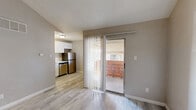 Located at 8930 Galewood Dr in Austin, TX 78758, this efficiently designed one-bedroom, one-bathroom unit offers a well-organized layout across a single floor. Light wood-style flooring flows consistently throughout, providing a clean, cohesive aesthetic.

The living area stands out with its vaulted ceiling, which adds a sense of openness and airiness. A sliding glass door with vertical blinds opens to a private balcony, allowing natural light to filter in and providing a connection to the outdoors.

The kitchen is thoughtfully arranged with white cabinetry, a built-in sink, stainless steel appliances including a full-size refrigerator and dishwasher, and a window fitted with blinds that brings in additional natural light. The white cabinetry and light countertops create a bright, functional workspace.

The bedroom features a ceiling fan with light fixture, a window with blinds for natural light and ventilation, and continues the light wood-style flooring found throughout the unit. The room offers a practical, comfortable layout suitable for a full bedroom setup.

The bathroom includes a full tub-shower combination, toilet, and maintains the same consistent flooring. The clean white fixtures and walls give the space a fresh, neat appearance. Overall, this unit delivers a straightforward, functional living space with cohesive finishes throughout.