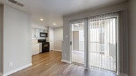 Located in Austin, TX (78741), this efficiently designed studio offers a practical and comfortable single-floor layout with one bedroom and one bathroom. Wood-style flooring runs throughout the space, creating a cohesive and warm aesthetic that ties each area together seamlessly.

The open main living area is bathed in natural light, courtesy of large windows fitted with horizontal blinds and a full-length sliding glass door that opens onto a private outdoor balcony. The balcony provides a pleasant extension of the living space and connects the interior to the outdoors. A textured ceiling adds a subtle design element throughout.

The kitchen is positioned in a dedicated alcove and features gray cabinetry, black appliances including a range and over-the-range microwave, a white dishwasher, and a tiled backsplash. Recessed lighting illuminates the kitchen area effectively.

The bedroom is a well-proportioned room with a ceiling fan, a generously sized window that allows ample natural light, and continued wood-style flooring, offering a calm and functional retreat.

The bathroom is clean and straightforward, featuring a full tub and shower combo with white subway tile surround, complemented by wood-style flooring consistent with the rest of the unit. This studio offers a practical and well-appointed living solution in Austin.