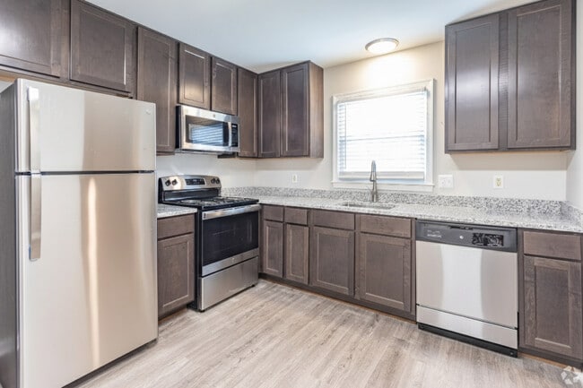 Modern Kitchens with Espresso Cabinetry, Stainless Steel Appliances, & Granite Countertops - Legacy at Tech Center