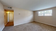 Located at 2975 Harrison St in Paducah, Kentucky, this single-floor, 2-bedroom, 1-bathroom home offers a practical and well-organized layout. The living room provides a comfortable gathering space with neutral-toned walls, soft carpeting, and a wide window that allows natural light to fill the room with views of the surrounding area. The kitchen is equipped with white cabinetry, light countertops, tile flooring, and stainless steel appliances including a dishwasher and electric range, offering both functionality and a clean aesthetic. The two bedrooms feature plush carpeting, neutral walls, and natural light from individual windows. The primary bedroom includes a walk-in closet with built-in shelving, providing ample storage. The second bedroom also features a standard closet and shares the same warm, understated design. The full bathroom is finished with tile flooring, a white vanity with a single sink, and a tiled tub-shower combination, maintaining a clean and cohesive look throughout. A hallway connects the bedrooms and bathroom, adding to the home's logical flow. The consistent use of neutral tones, tile, and carpet throughout creates a calm and move-in-ready atmosphere.