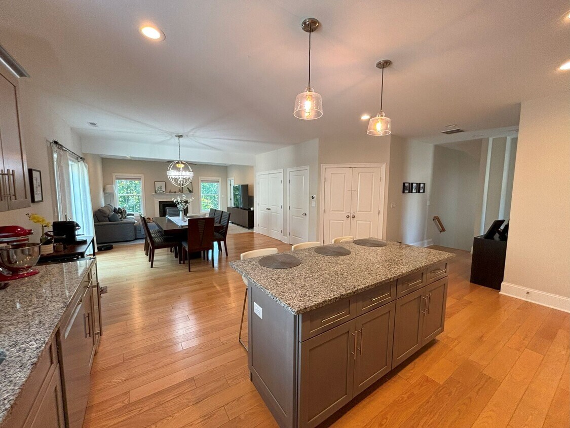 Main floor, kitchen with stainless steel appliances & granite countertops, opens into dining/living - 140 Wells View Rd