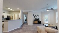This single-story, one-bedroom, one-bathroom residence in Baton Rouge, Louisiana offers a thoughtfully designed open-concept layout finished with consistent wood-style flooring and neutral tones throughout. Crown molding accents the living area, where large windows invite generous natural light and provide outdoor views. A ceiling fan overhead and a private exterior door add both comfort and convenience to the living space.

The kitchen features granite-look countertops, white cabinetry, stainless steel appliances including a refrigerator and microwave, and a peninsula that opens toward the dining area — ideal for casual dining or entertaining. The adjacent dining space provides a seamless connection between cooking and living areas.

The bedroom is a calm retreat with a ceiling fan, wide windows with exterior views, and direct access to a walk-in closet that offers generous storage. The full bathroom is finished with white cabinetry, granite-style countertops, a tub-shower combination, and coordinating wood-style flooring.

A dedicated in-unit laundry area with a full-size washer and dryer adds everyday practicality. Throughout the unit, recessed lighting and clean architectural lines contribute to a contemporary, cohesive ambiance.