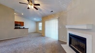 Located at 5450 Firewater Ln. in Columbus, Ohio, this single-floor home offers a comfortable and functional layout throughout. The spacious living room serves as the centerpiece of the home, featuring a classic fireplace with a white mantel, plush carpeting, and vaulted ceilings with a ceiling fan overhead. A sliding glass door floods the space with natural light while providing access to the outdoors, and a built-in pass-through niche connects seamlessly to the adjacent areas. The kitchen is well-appointed with warm wood cabinetry extending to the ceiling for ample storage, dark granite-style countertops, hardwood-style flooring, and stainless steel appliances including a range, microwave, and refrigerator. The bedrooms are carpeted and finished in neutral tones, each offering closet space and windows with horizontal blinds that allow for natural light. The bathroom features warm wood vanity cabinetry, a wide countertop with an integrated sink, a large mirror, and a full tub-shower combination with tile flooring. Throughout the home, neutral wall colors, consistent trim work, and practical finishes create a cohesive and inviting atmosphere well-suited for everyday living.