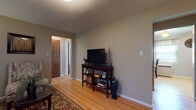 Located at 264 Faller Dr in New Milford, NJ, this single-floor residence offers a well-organized and comfortable layout. The living area features warm hardwood flooring, neutral taupe walls, and a media console with open shelving, creating a relaxed and functional space. Adjacent to it, a cozy sitting nook benefits from large windows dressed with sheer curtains, allowing generous natural light to fill the room.

The kitchen is equipped with warm wood cabinetry, a gas range, over-the-range microwave, dishwasher, and a sink with laminate countertops. A charming dining nook nearby features a window with outdoor views, providing a pleasant spot for casual meals.

The two bedrooms are each finished with hardwood floors and neutral walls. One bedroom features dual windows with blinds and drapery, while the other offers a cozy, well-appointed layout with framed wall art and ample surface space. Both rooms provide a calm and restful atmosphere.

The full bathroom includes a tub-shower combination with tiled surround, a single-sink vanity with white cabinetry, tile flooring, and a medicine cabinet with mirror. A window adds natural ventilation and light. Throughout the residence, the consistent flooring, neutral palette, and practical layout contribute to a cohesive and inviting living environment.