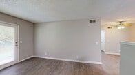Located on E Kingwood Dr in Murfreesboro, Tennessee, this single-floor, 4-bedroom, 3-bathroom home offers a practical and well-organized layout. The kitchen is outfitted with white shaker-style cabinetry, marble-look countertops, light wood-style flooring, and stainless steel appliances including a range, dishwasher, and refrigerator — providing ample workspace and storage for everyday use. The bedrooms are carpeted in warm neutral tones with soft gray walls and textured ceilings, creating a comfortable and consistent feel throughout. Several bedrooms include built-in closets with louvered bifold doors, offering convenient storage. One bedroom features a window with natural views of surrounding greenery, adding a bright, pleasant atmosphere. The three bathrooms are finished in a clean, modern style with white vanities, marble-look countertops, and wood-look flooring. One full bathroom includes a tub-shower combination with white tile surround, a round mirror, and a lighted vanity fixture above. A hallway connects the rooms efficiently across the single floor, and a dedicated closet provides additional storage. The home's consistent neutral palette, updated finishes, and functional layout make it a well-rounded residential space in a convenient Murfreesboro location.